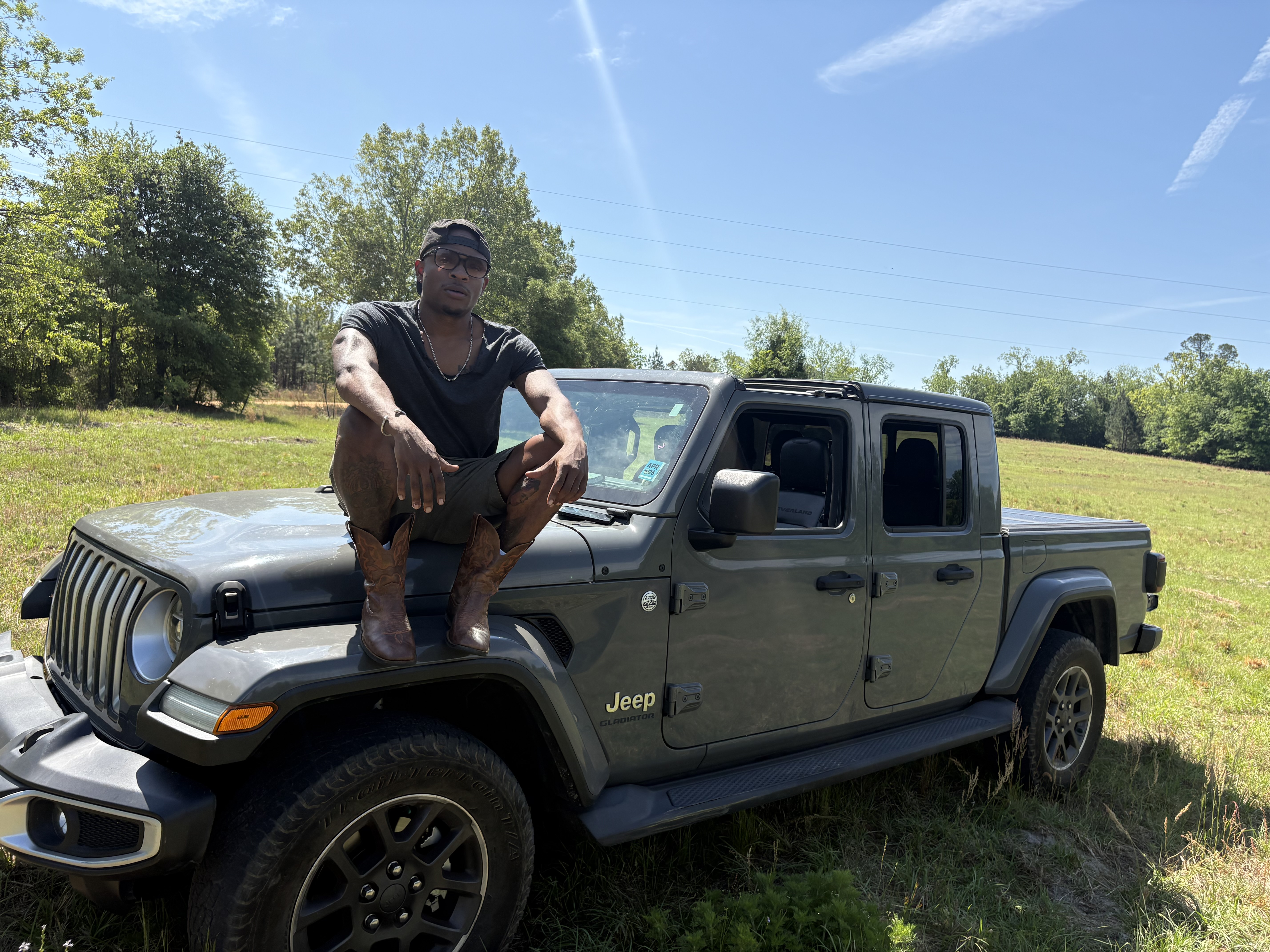 Hunter Reed outdoors on the farm with a Jeep